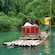 A couple look adoringly into each other's eyes as they enjoy a bamboo raft ride down the river